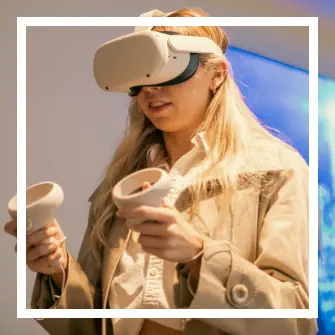 Student using Meta Quest 2 headset and grips