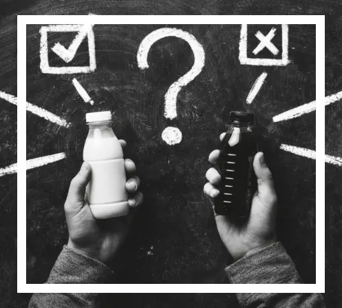 Person holding two bottles, one white and the other black, and chosing between them