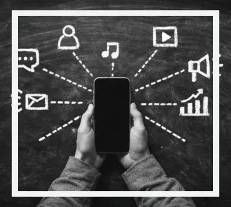 Person holding phone with digital marketing symbols